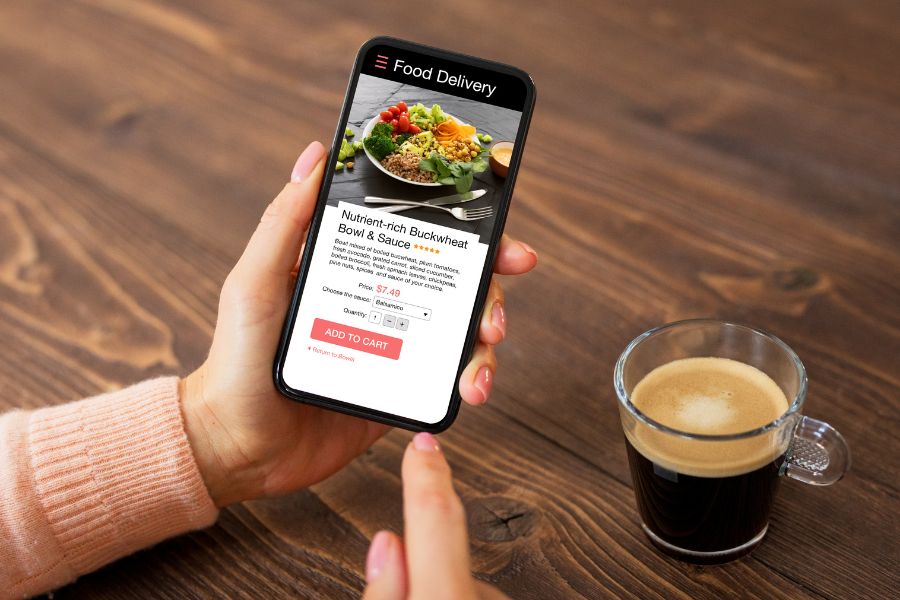 Woman ordering food online using food delivery app